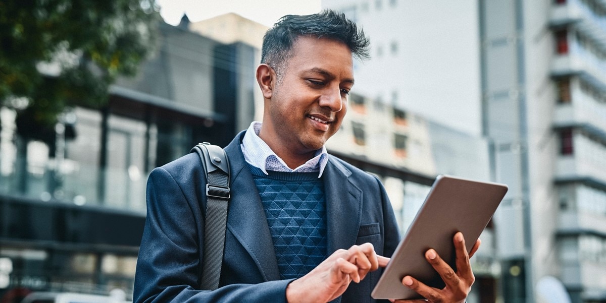 travler standing outside looking at tablet