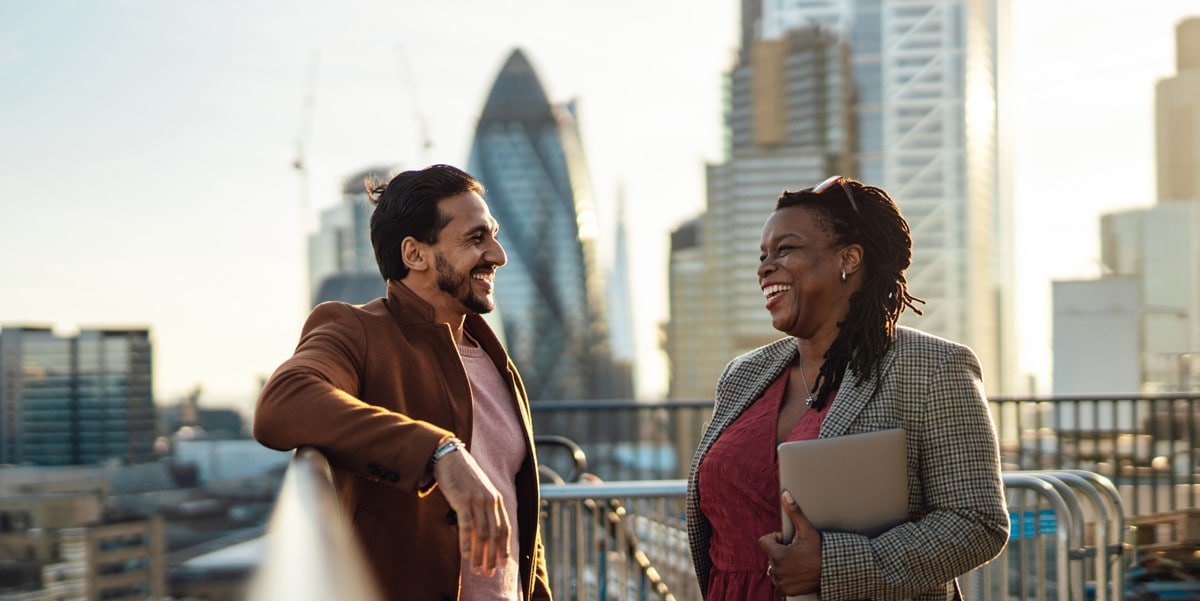 two professionals speaking, outdoors, cityscape